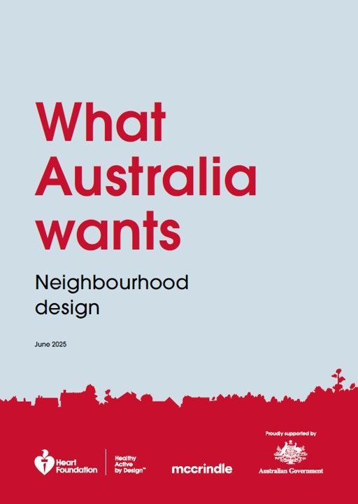 Young girl in green coat reaching for a bubble in a park.