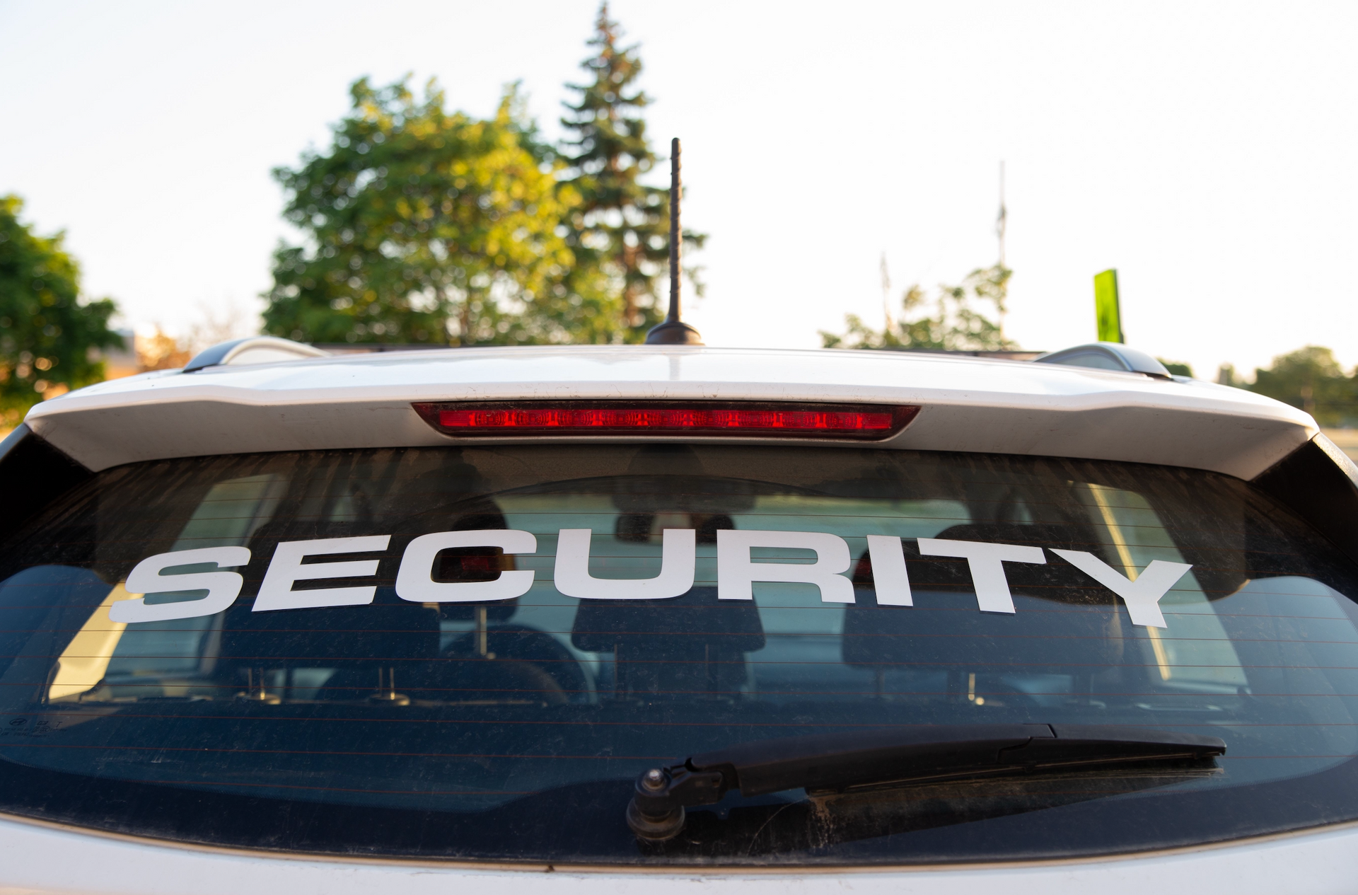 A car with a security sticker on the back window