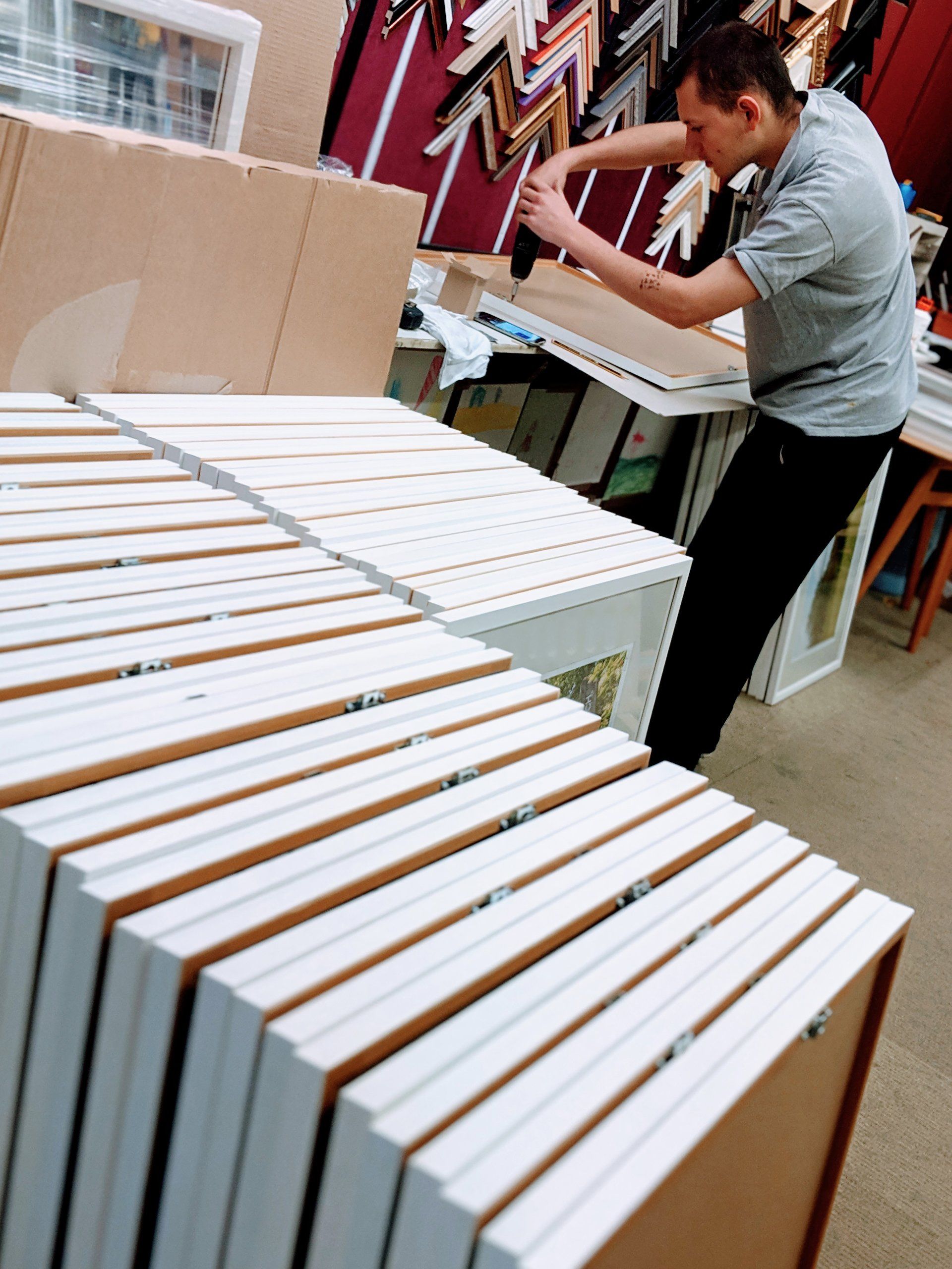 Frames of a wide range of sizes hung and frame sticks laid