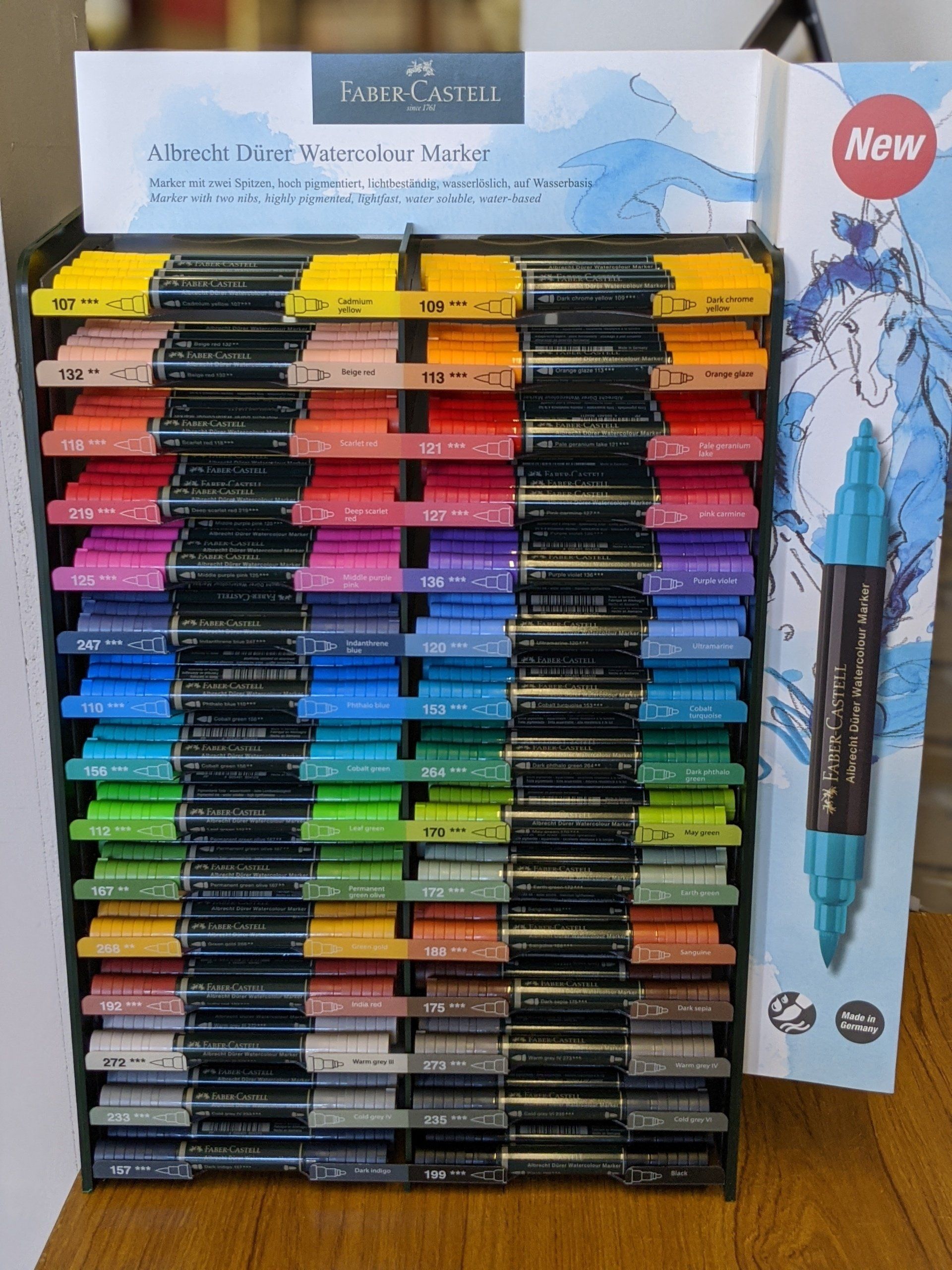 art products including books and canvases stacked on the display shelf