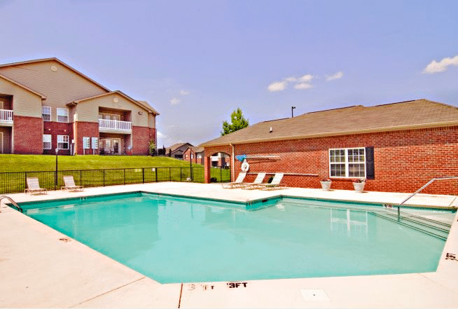 Photo of pool, a poolhouse and the building in the back