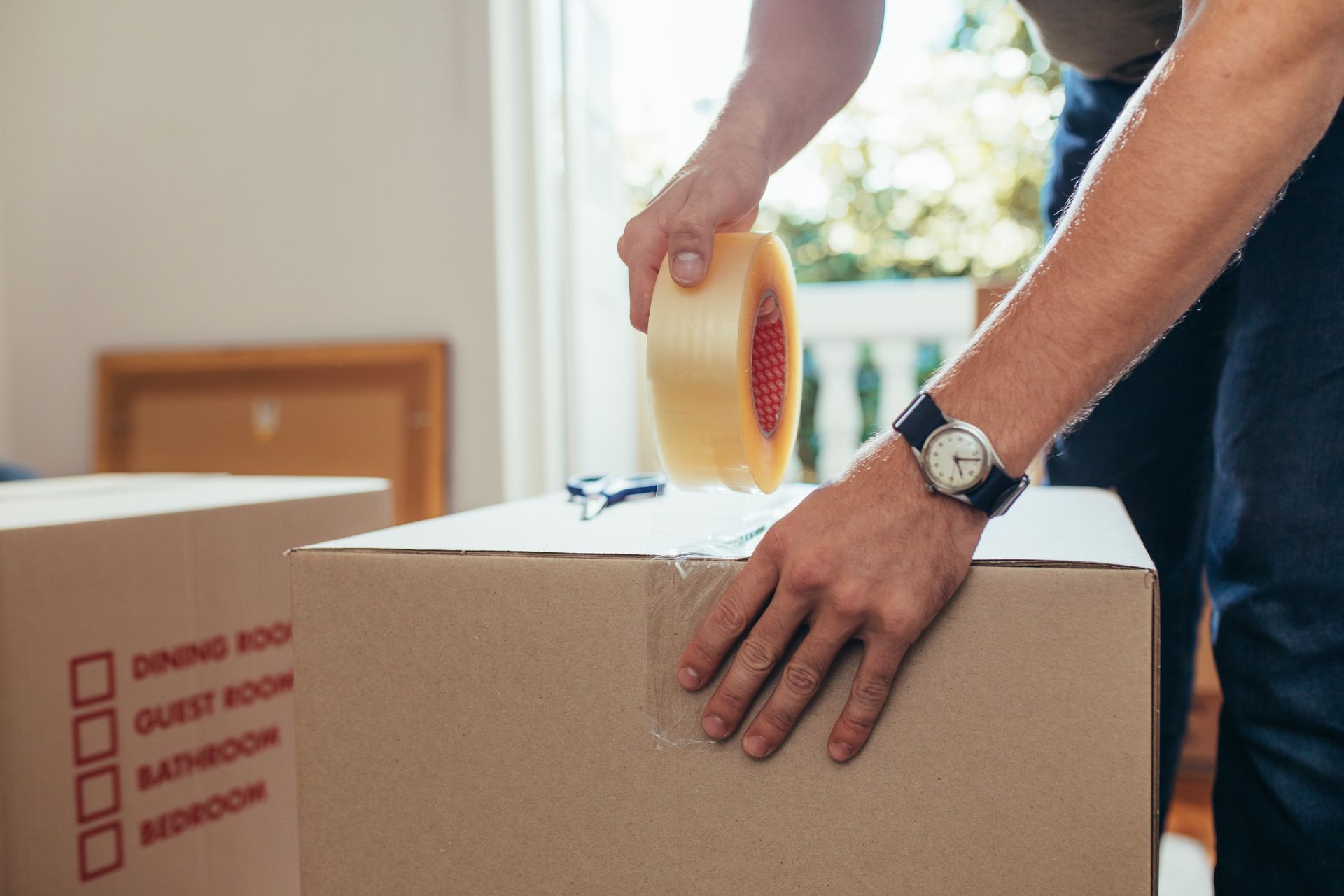 A full-service mover packing boxes