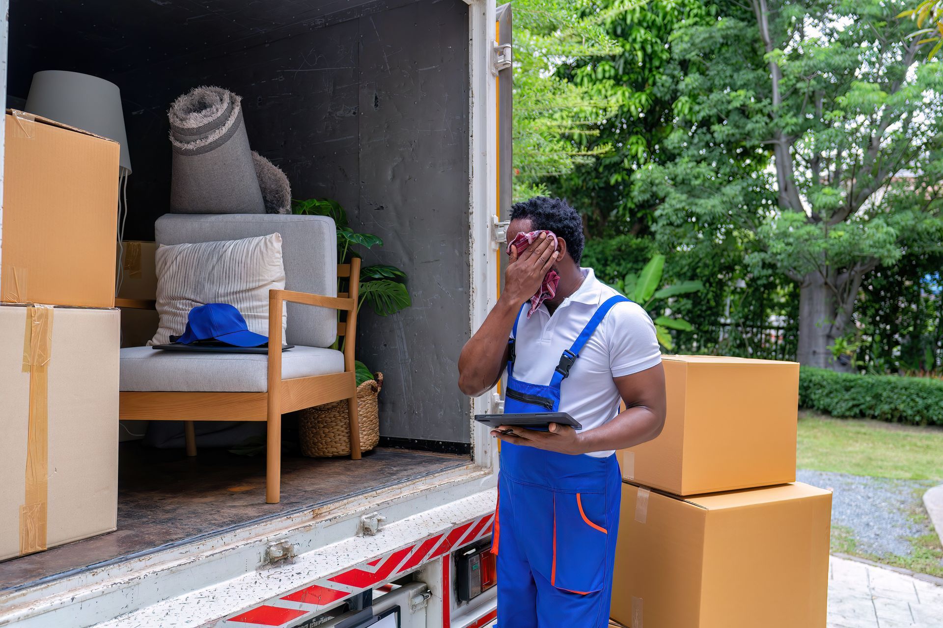 A professional mover working in the heat of summer.