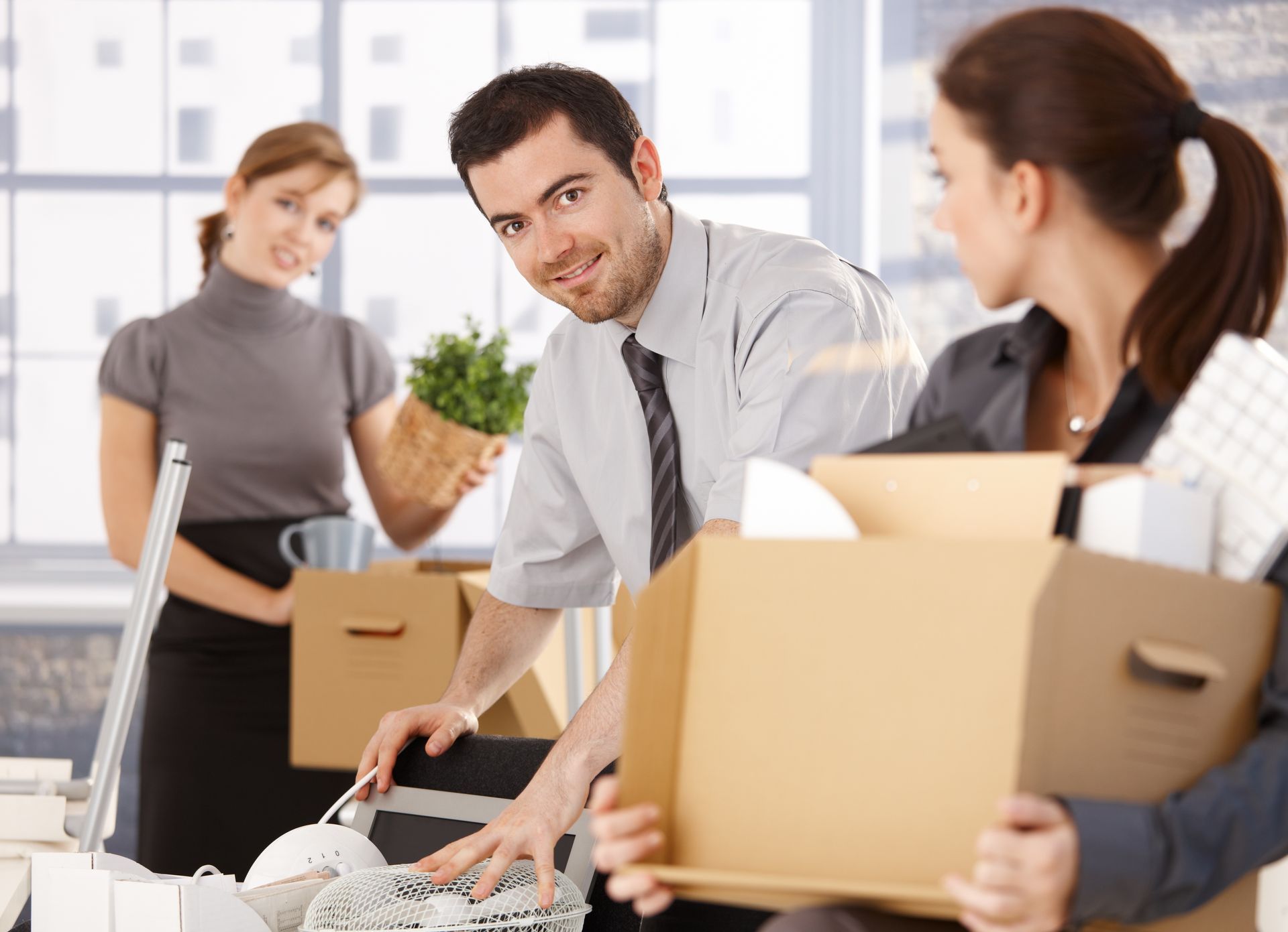 A handful of employees pack up their desks for an office move.