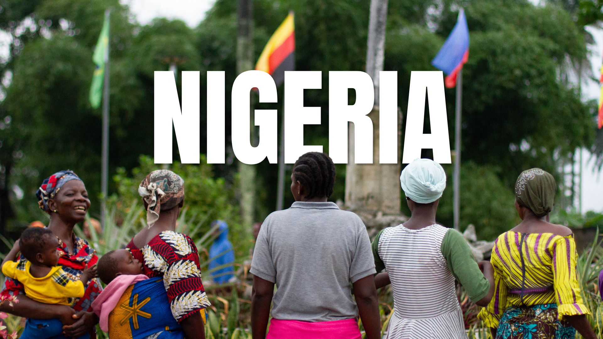 Scenic view of Nigeria, with lush greenery in the foreground and a large rock formation in the background.
