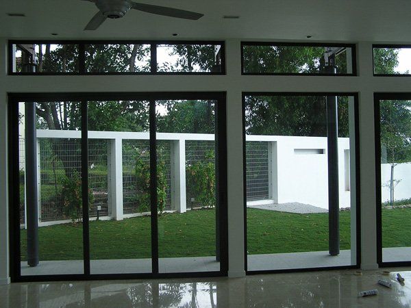 A room with  windows and sliding doors