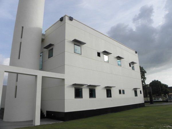 A white building with a tower on top of it
