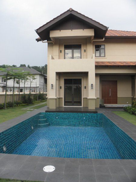 A large house with a large swimming pool in front of it