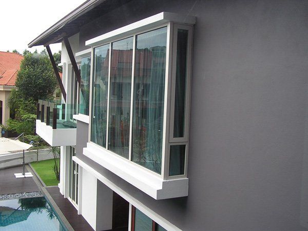 A large house with a swimming pool in front of it