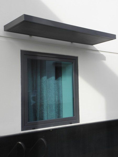 A window with a black shelf above it