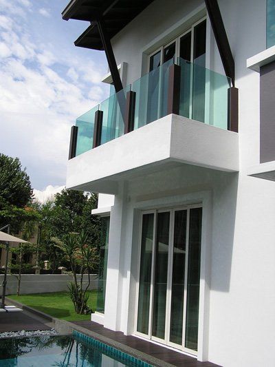 A white house with a swimming pool in front of it