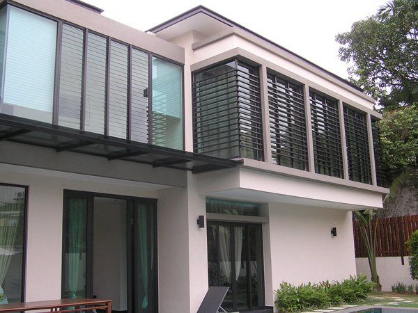A large white house with a swimming pool in the backyard