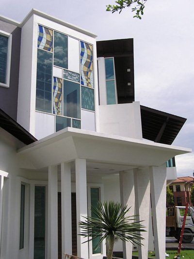 A white house with a palm tree in front of it