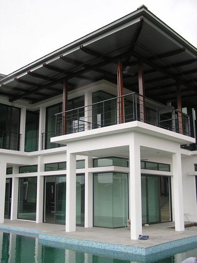 A large white house with a swimming pool in front of it