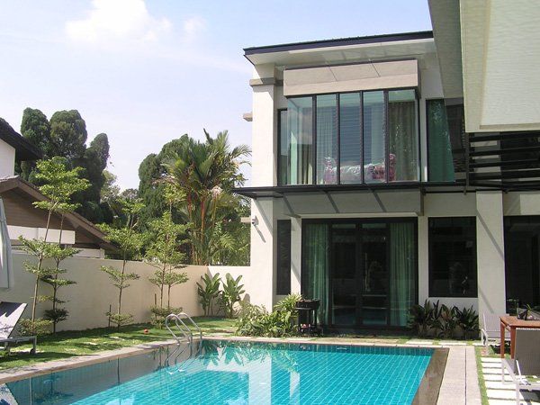 A large house with a swimming pool in front of it