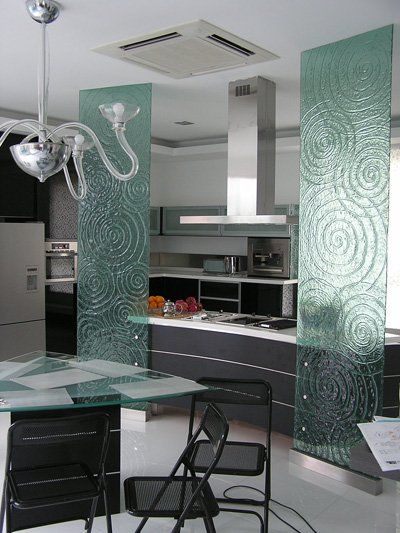A kitchen with a table and chairs and a ceiling fan