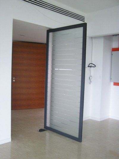 A sliding glass door in a room with a wooden door