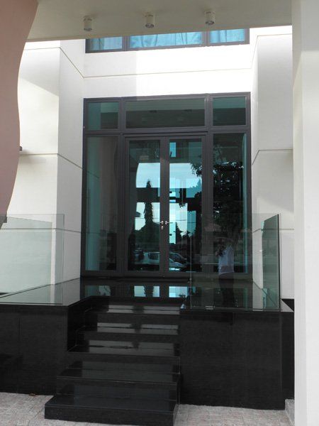 A building with a large glass door and stairs