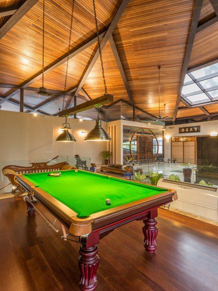 There is a pool table in the middle of the room.