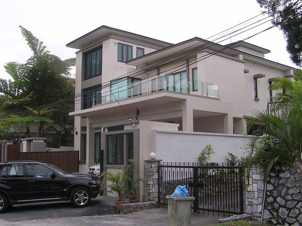 A black suv is parked in front of a large house