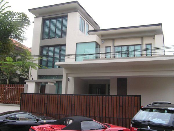 A red sports car is parked in front of a house