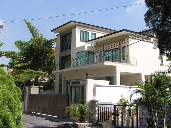 A large white house with a fence around it