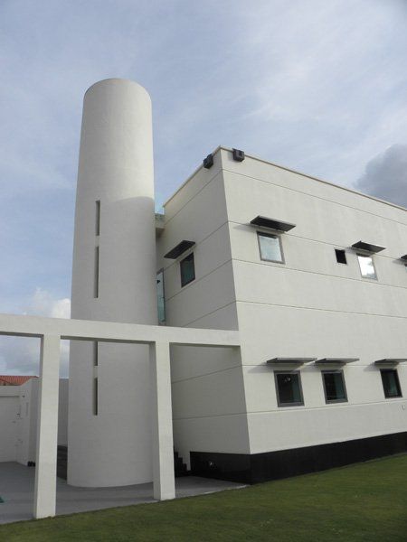 A white building with a tower on top of it