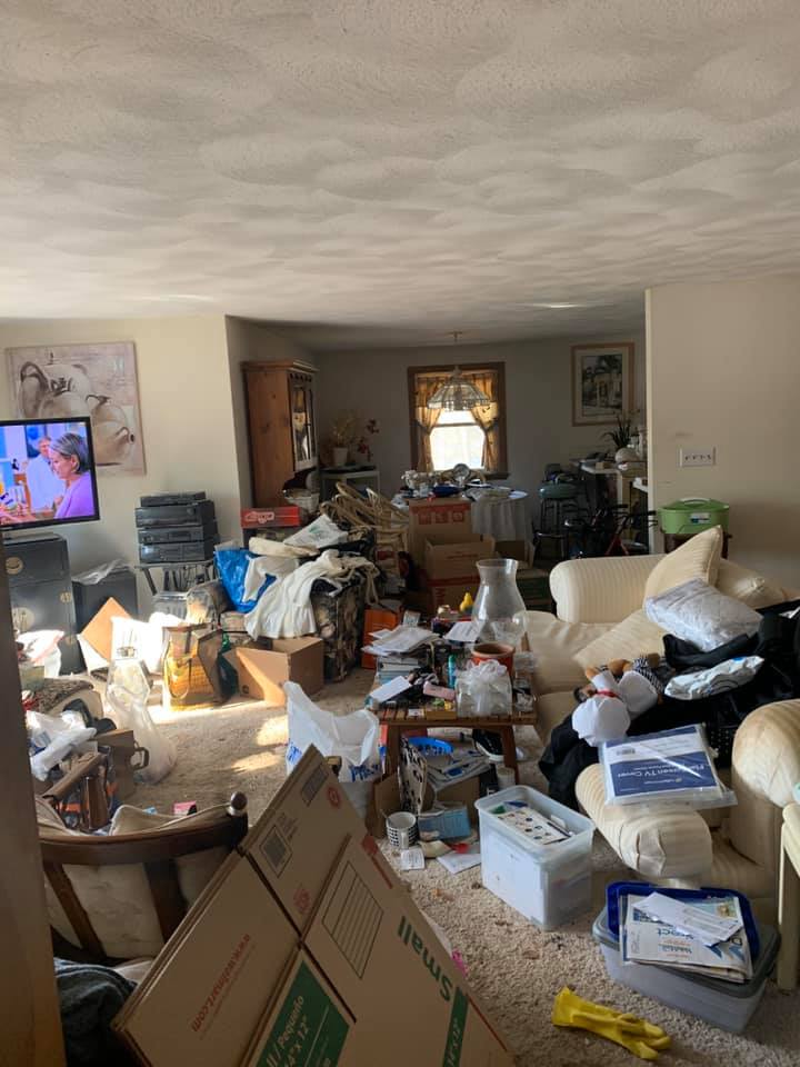 A living room filled with lots of boxes and a television.