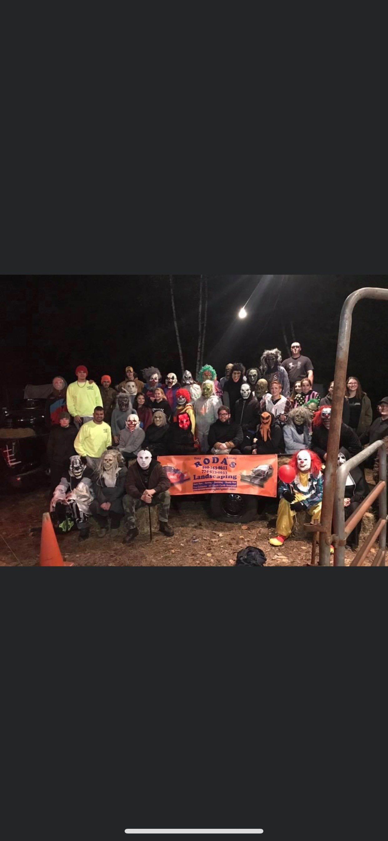 A group of people are posing for a picture in the dark.