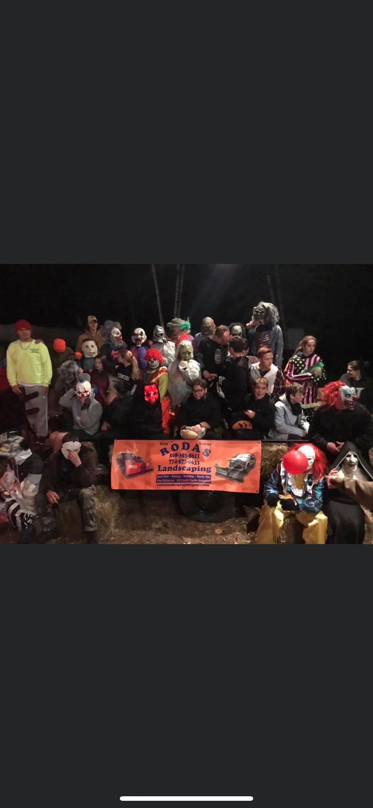 A group of people are posing for a picture in a dark room.