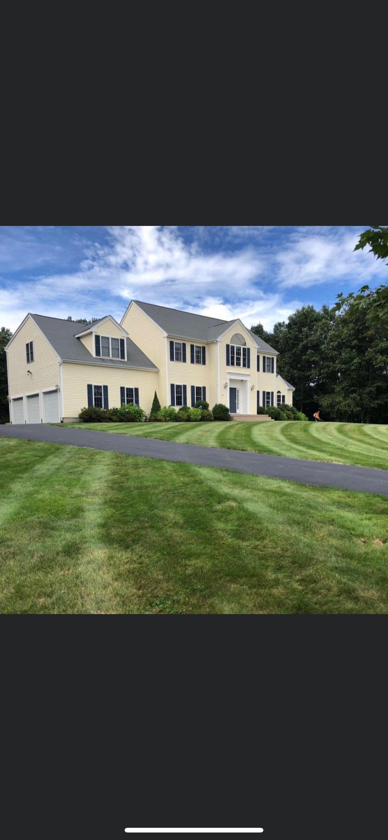A large house with a lush green lawn in front of it.