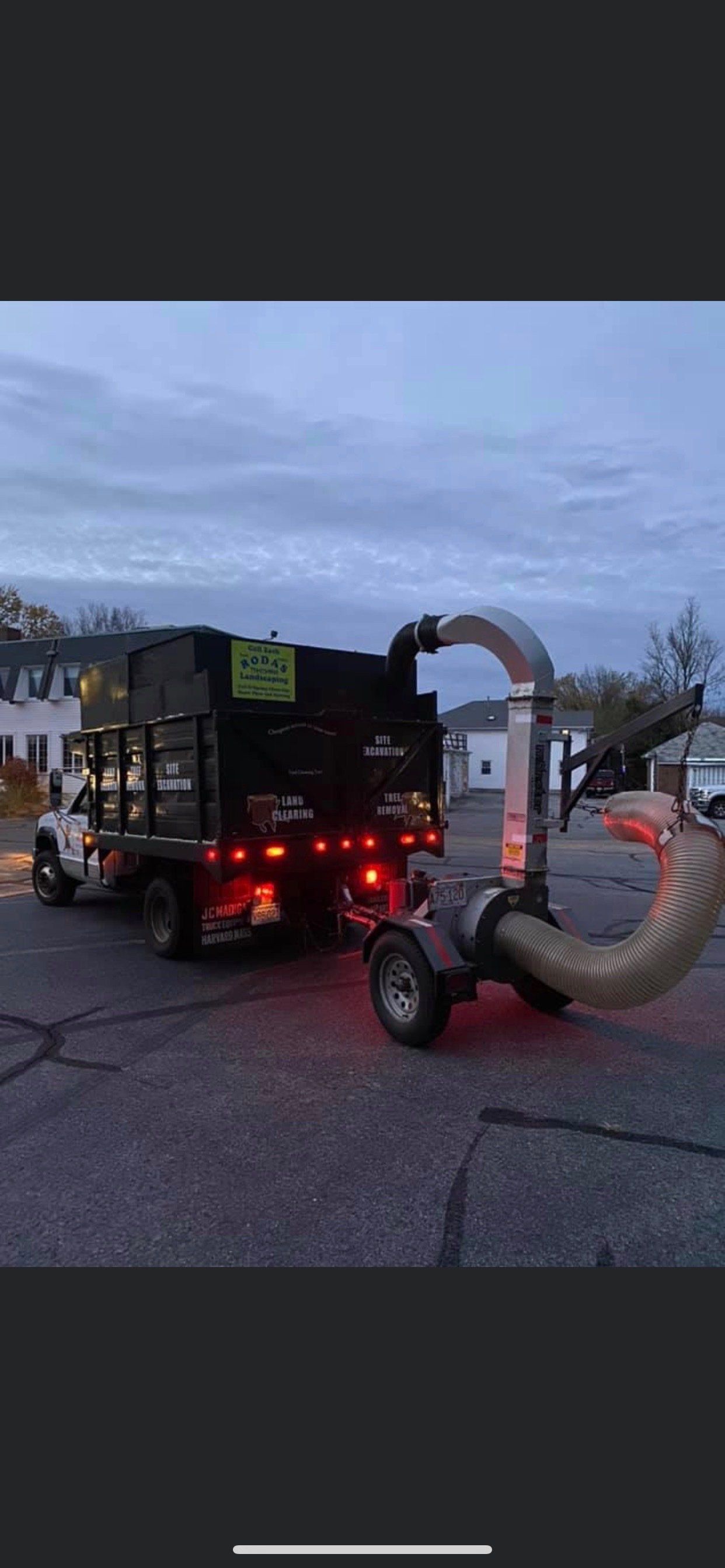 A leaf blower is attached to the back of a truck.
