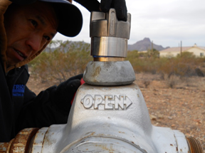 Water Main Installation Services — Man Opening the Valve in Tucson, AZ