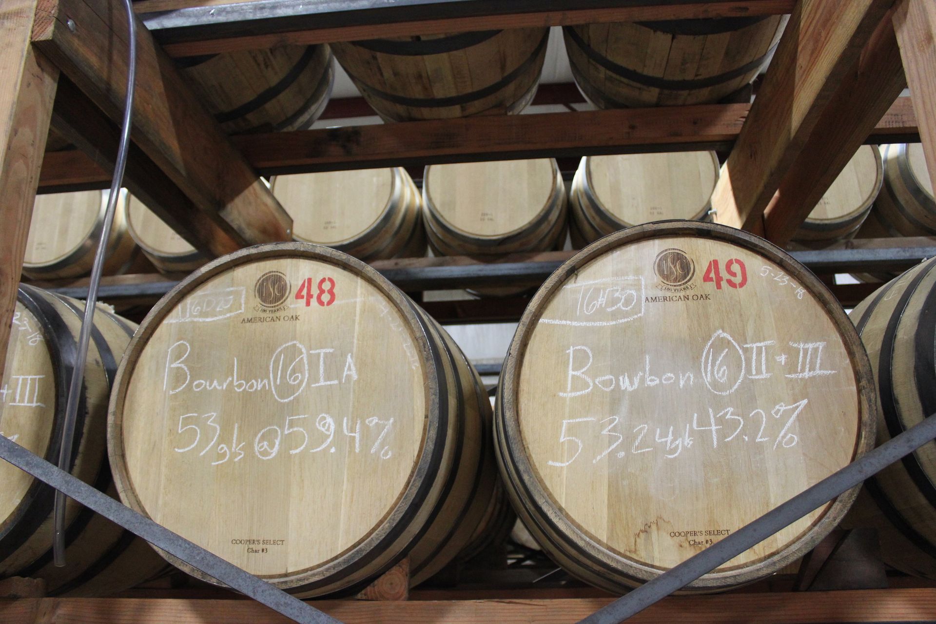 A row of wooden barrels with the numbers 48 and 49 on them