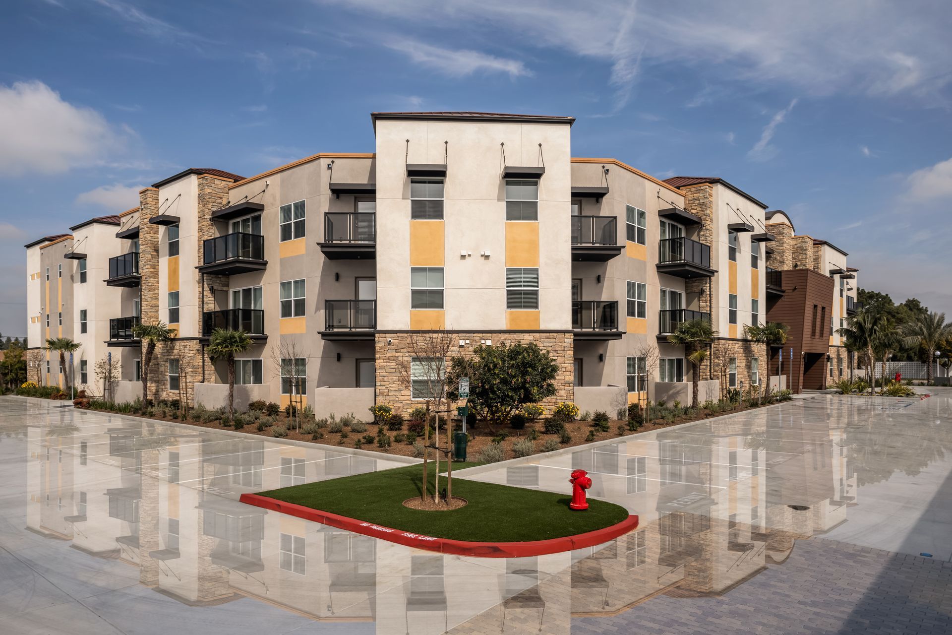 A large apartment building with a fire hydrant in front of it