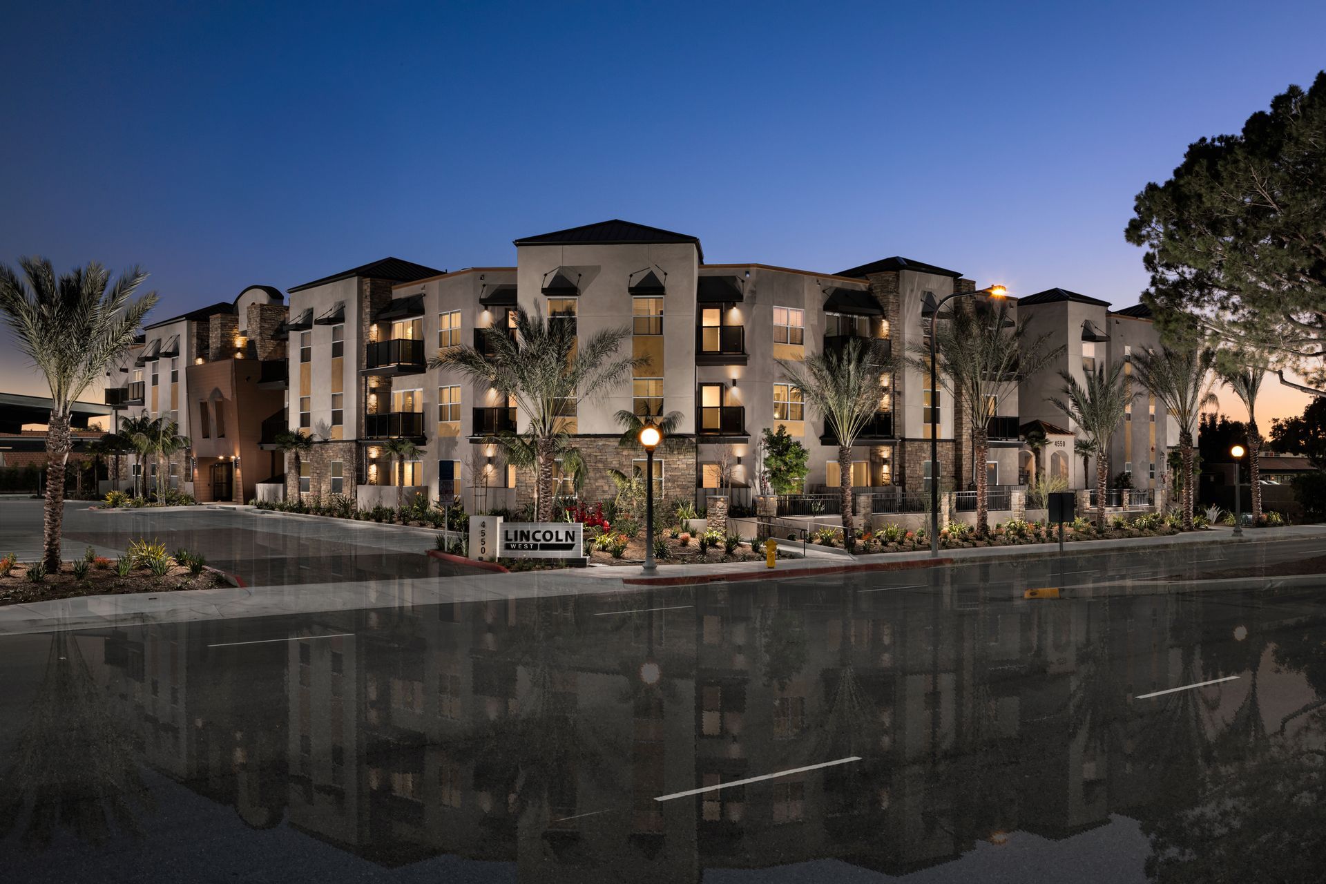 A large apartment building is lit up at night