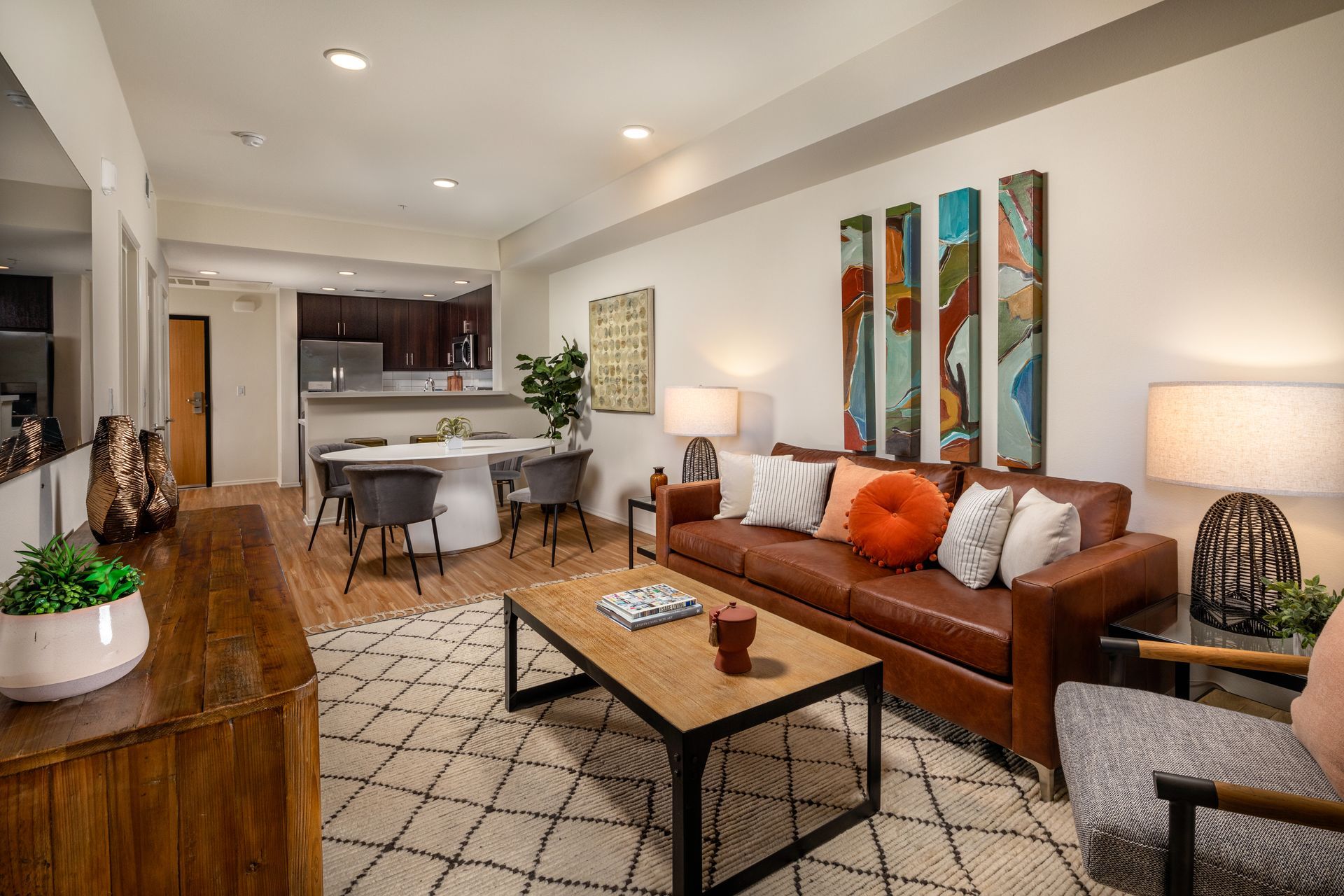 A living room with a brown leather couch and a wooden coffee table.