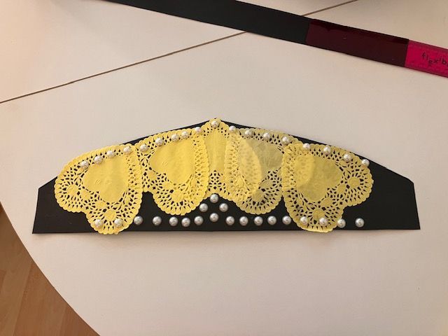 Yellow lace doily garland on a black strip with white dot accents