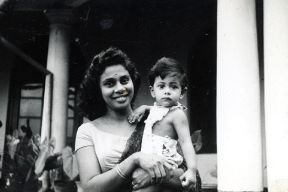 A black-and-white photo of Tammy Fernando as a child being held by her mom.