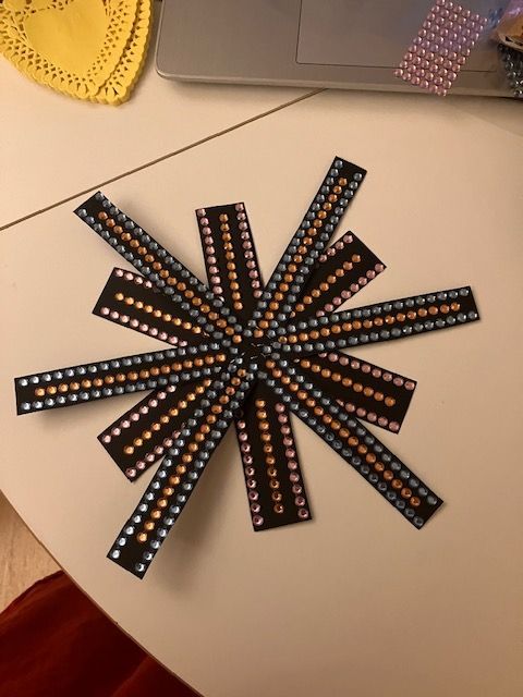 Radial arrangement of black LED strips with blue and orange lights on a tabletop