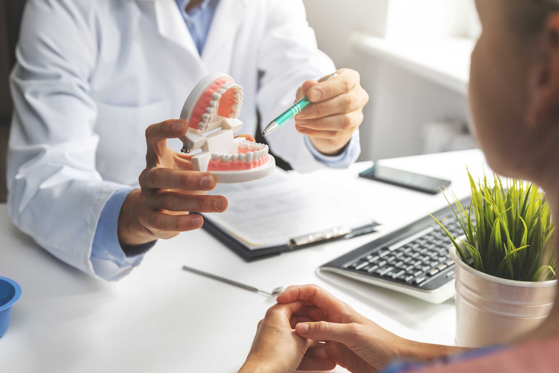 A patient is having a consultation with a dentist at a dentist clinic. A patient is having a consultation with a dentist at a dentist clinic.