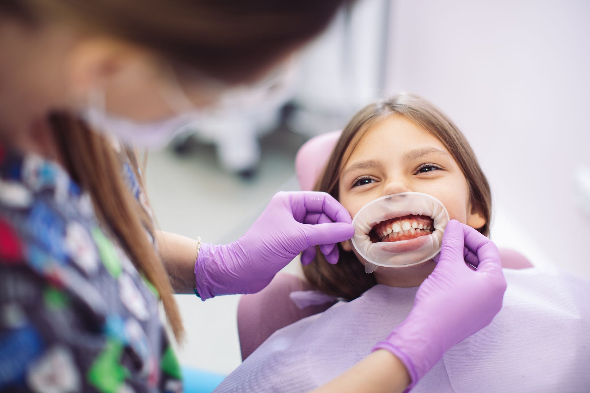 A child receives gentle pediatric airway dental treatment from a caring dentist in the clinic.