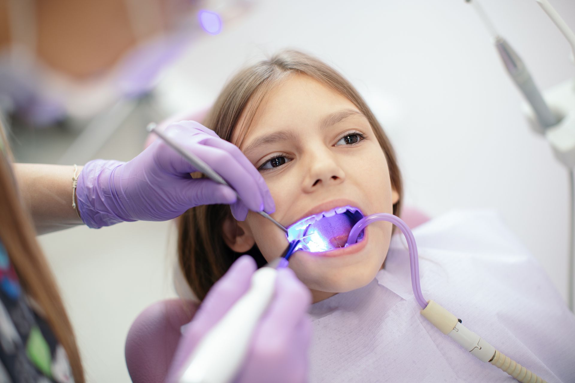 A dentist examines a young girl’s teeth during a Pediatric Airway Dental Treatment appointment. A dentist examines a young girl’s teeth during a Pediatric Airway Dental Treatment appointment.