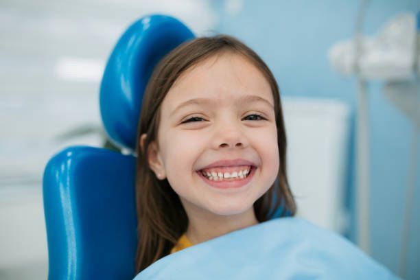 Little Girl Visiting a Dentist and Smiling