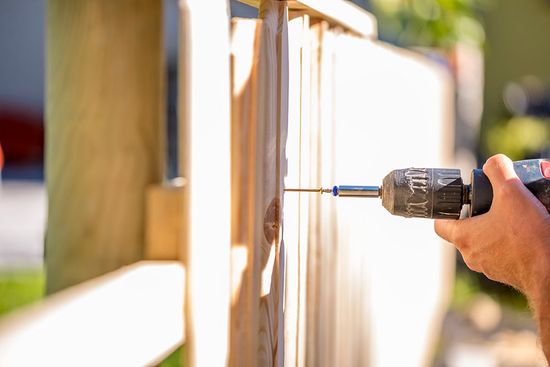Man Erecting a Wooden Fence — Atlanta, GA — West Georgia Fence Co