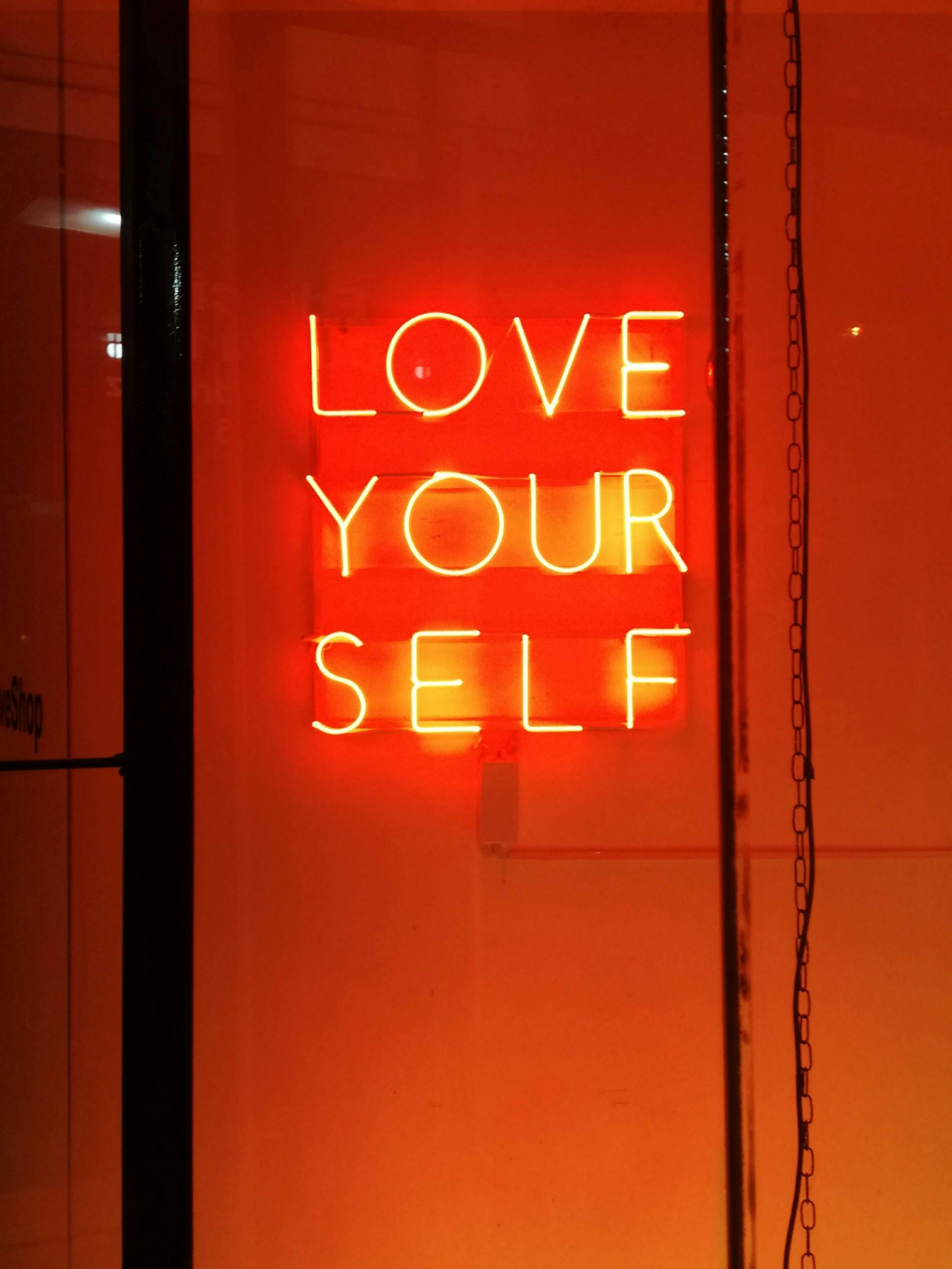 A neon sign that says love your self on it
