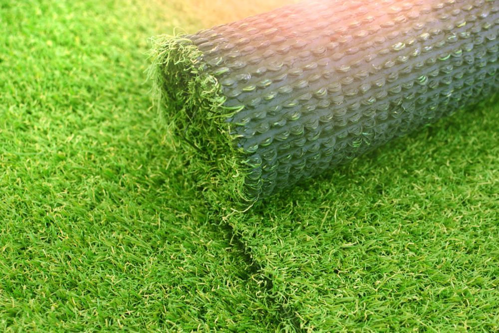 Roll of Artificial Turf Unrolling onto A Green Surface — East Coast Hydroseeding in Cooperabung, NSW