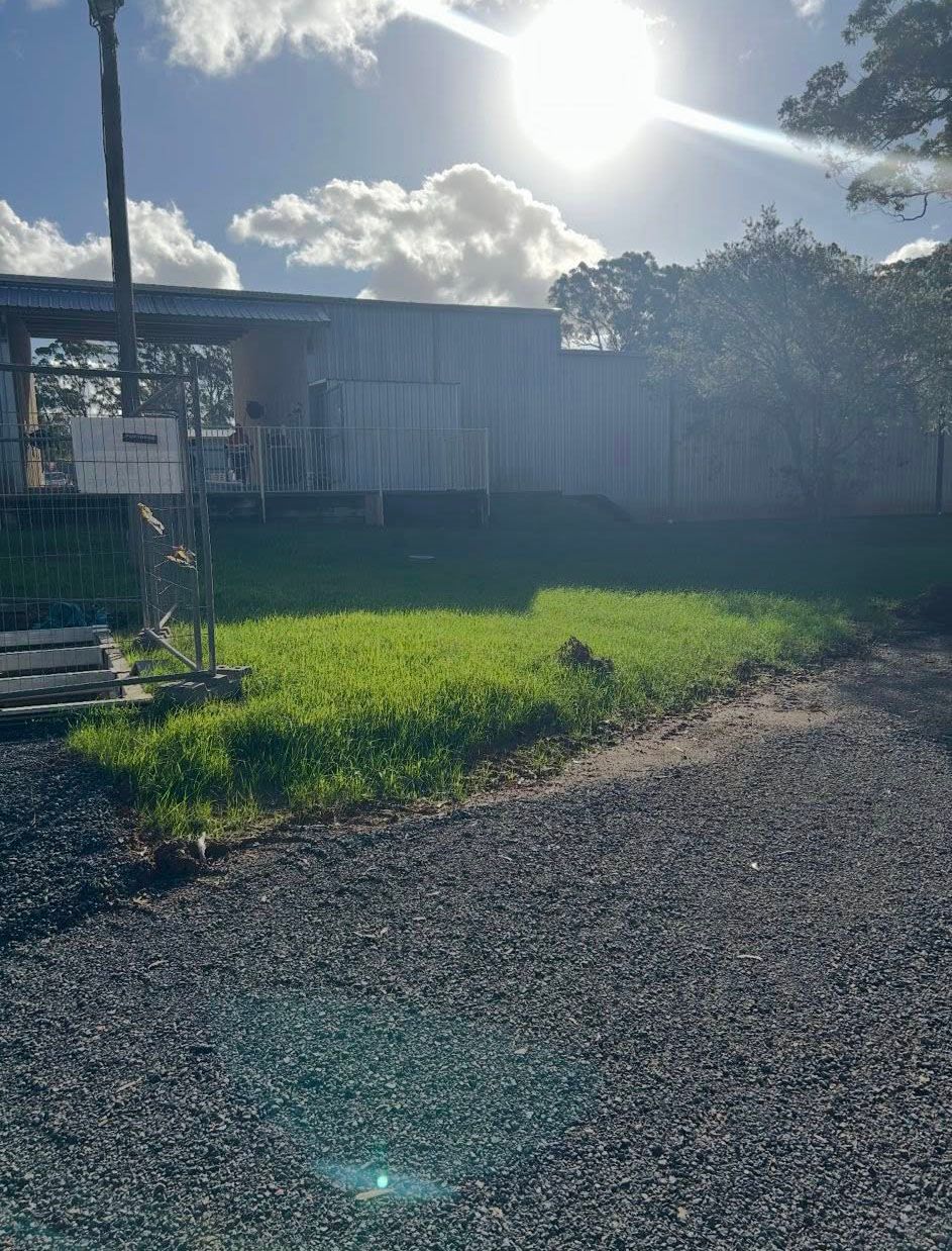Bright Sunny View of A Grassy Lawn, Gravel Path — East Coast Hydroseeding in Coffs Harbour, NSW