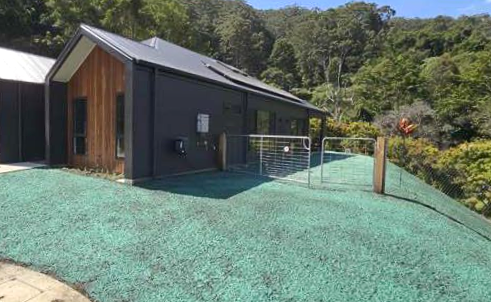 Green Artificial Turf Yard with Stone Borders — East Coast Hydroseeding in Cooperabung, NSW