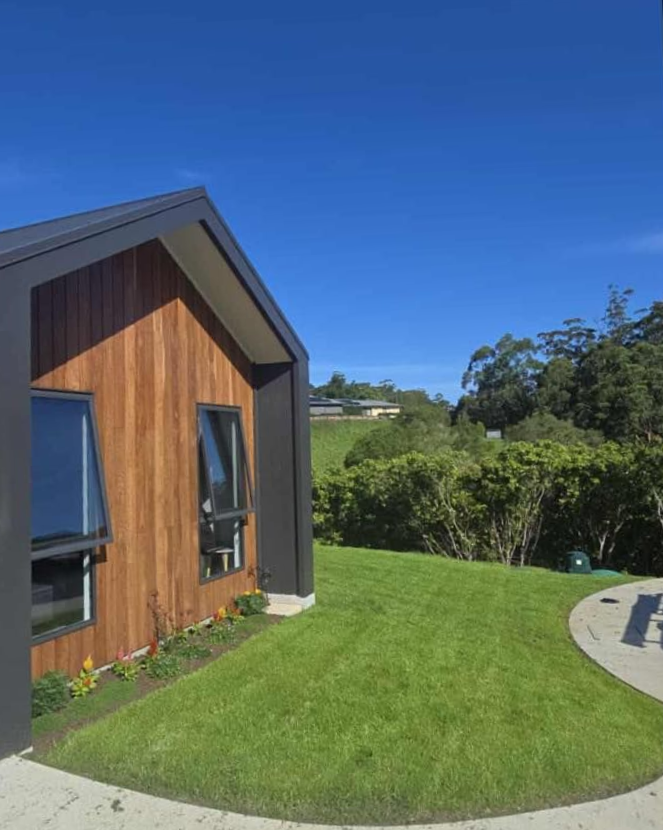 Modern House with Wooden Siding, Black Trim — East Coast Hydroseeding in Forster, NSW